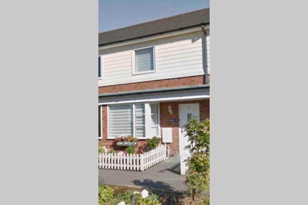 an image of a house with a garage at Comfy 2 bed house located at Wareham train station in Wareham