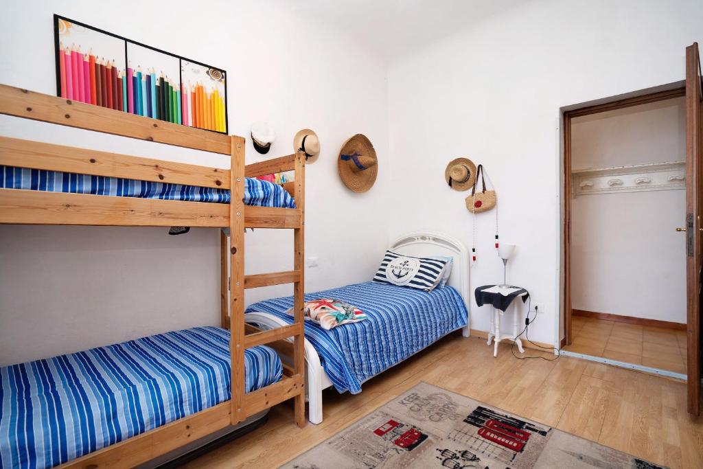 sypialnia z 2 łóżkami piętrowymi i drzwiami w obiekcie Villa Lardarina w mieście Corniglia