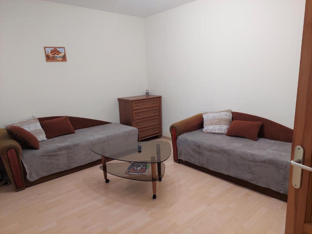 uma sala de estar com um sofá e uma mesa de centro em Butas Palangoje em Palanga