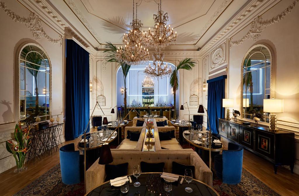 a dining room with tables and a chandelier at Palazzo Dama - Preferred Hotels & Resorts in Rome