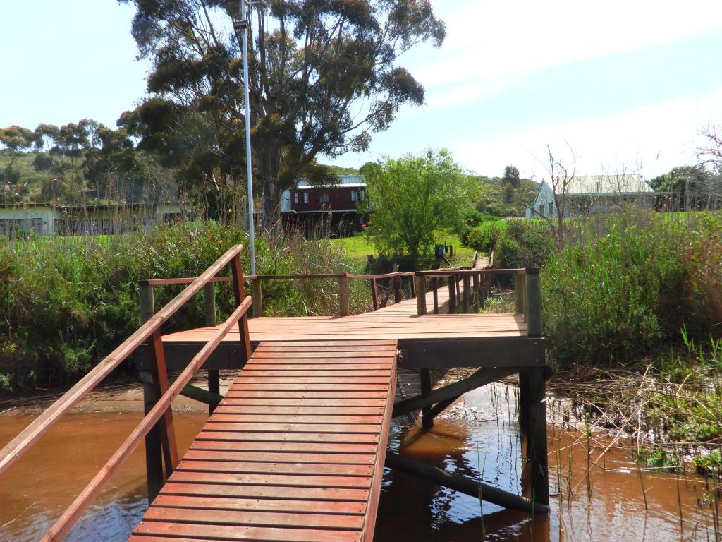 a wooden bridge over a body of water at Ashanti House - Living The Breede in Malgas