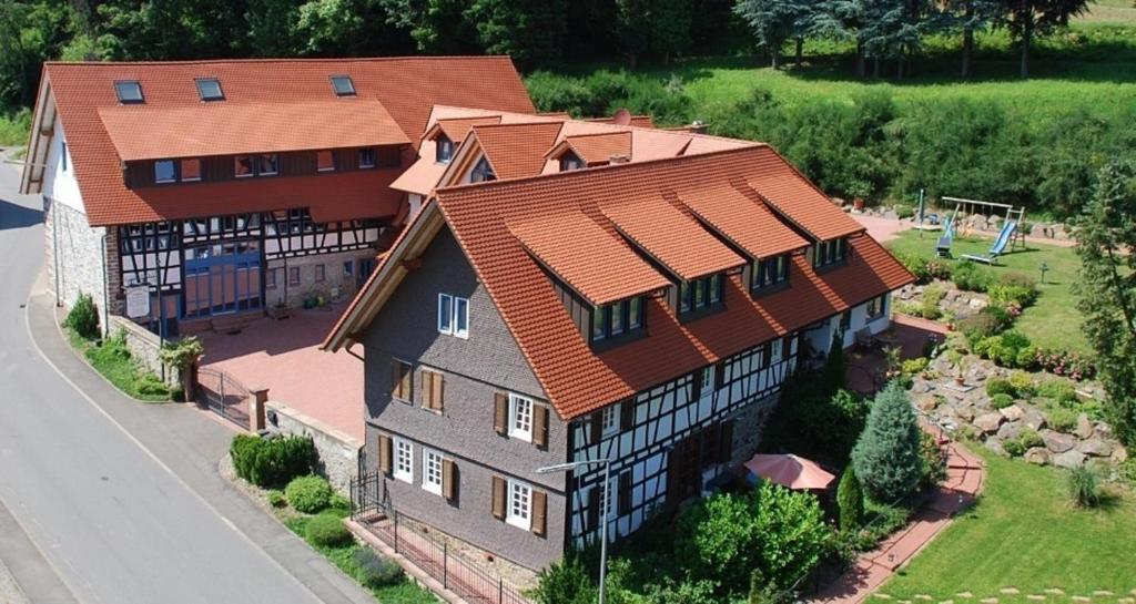 an overhead view of a large house with red roof at Glattbacher Hof Ferienwohnung 8 in Glattbach