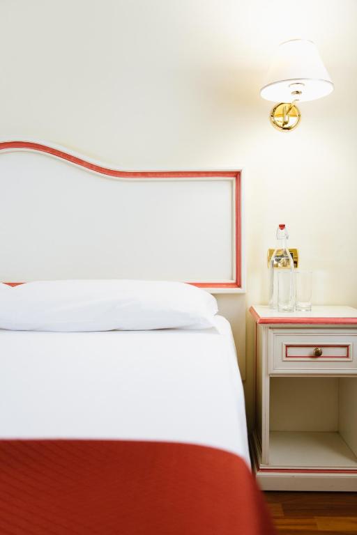 a bedroom with a bed and a window and a table at Hotel Do Pozzi in Venice