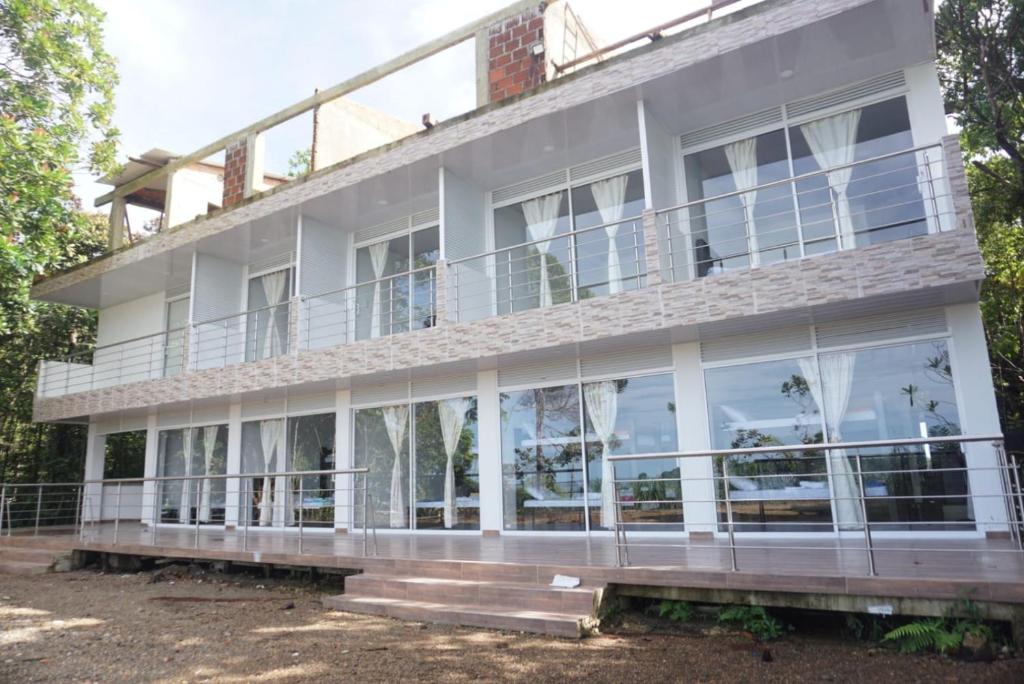an exterior view of a building with large windows at La Manigua hostal in Buenaventura