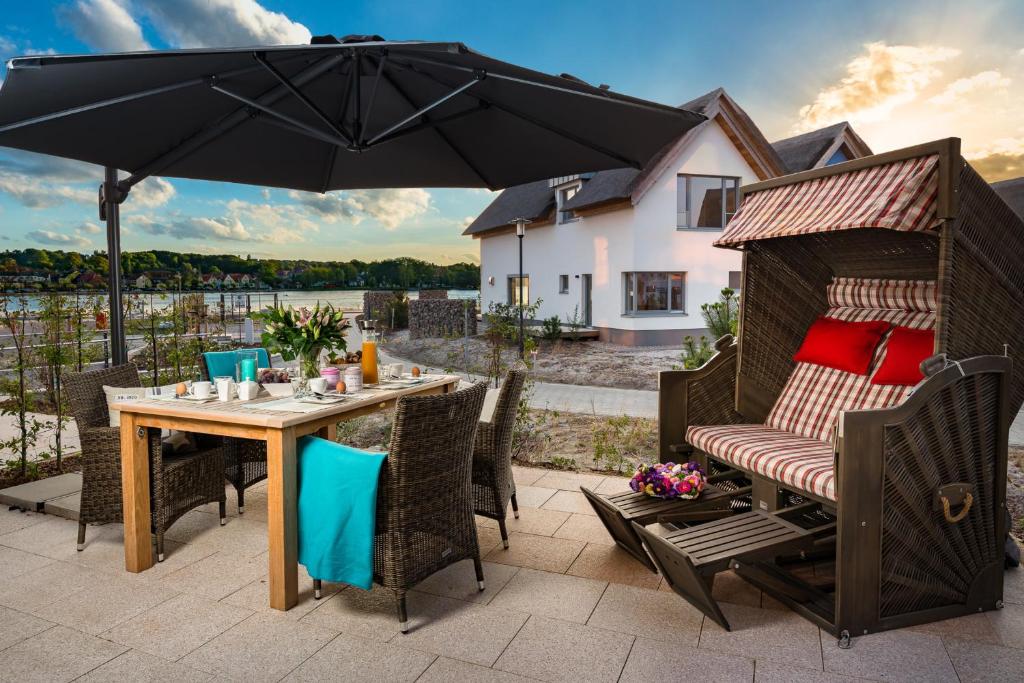a patio with a table and an umbrella at Ostsee - Appartement Nr 161 "Strandgut" im Strand Resort in Heiligenhafen