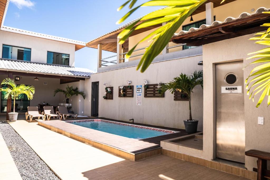 a swimming pool in the backyard of a house at Pousada Boipeba Beach in Ilha de Boipeba