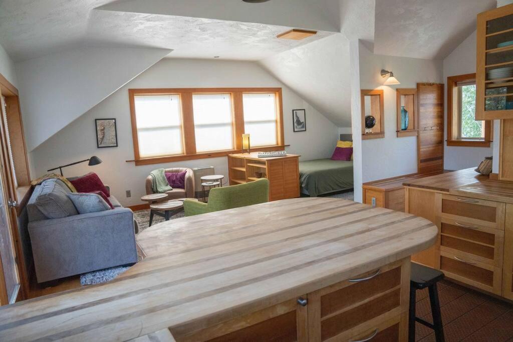 a kitchen and living room with a wooden table at Lofty Heights- A Teton Experience in Driggs