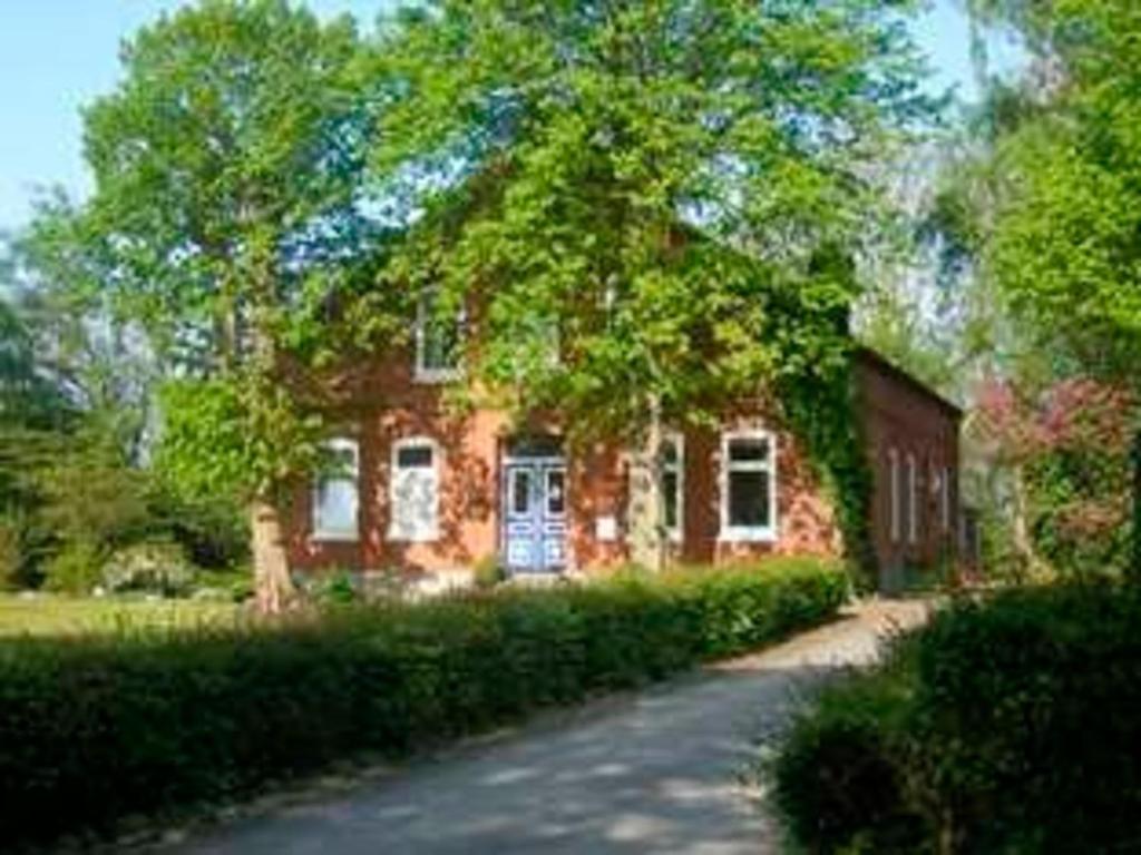 a brick house with a driveway in front of it at "Ferienhaus Vadersdorf" Wohnung 2 in Vadersdorf