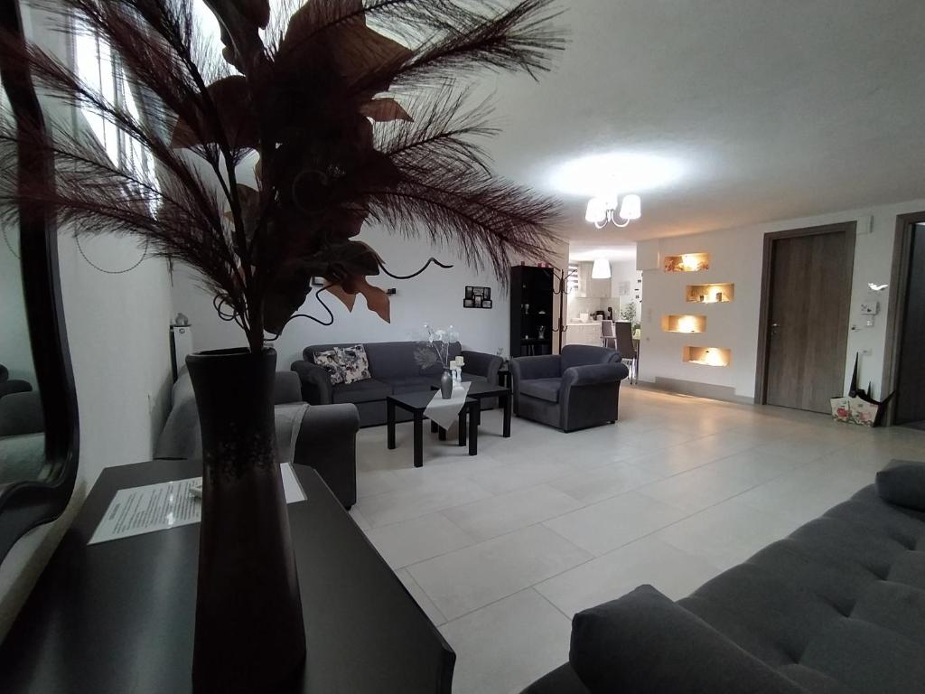 a living room with couches and a vase with a plant at MY HOME Trikala in Tríkala