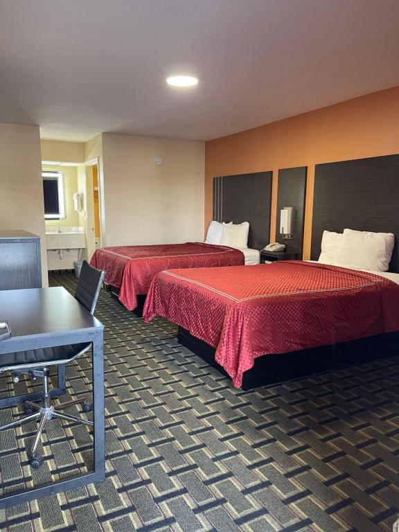 a hotel room with two beds and a table at New Hampshire Inn West Memphis in West Memphis