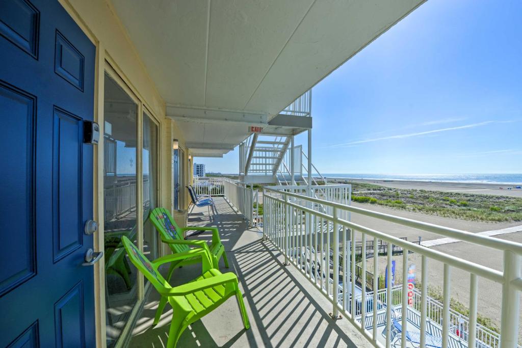 a balcony with green chairs and the beach at Sun-Soaked Wildwood Getaway, 6 Mi to Cape May! in Wildwood Crest