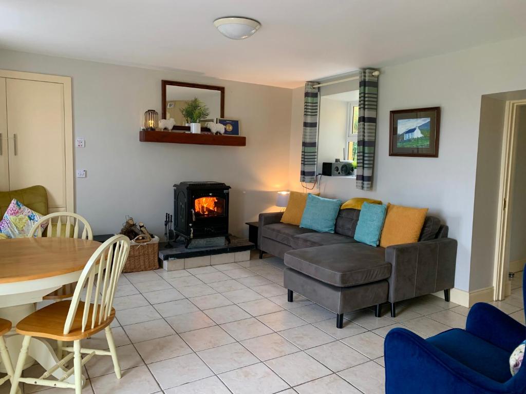 a living room with a couch and a fireplace at Hidden Hills Waterville in Waterville