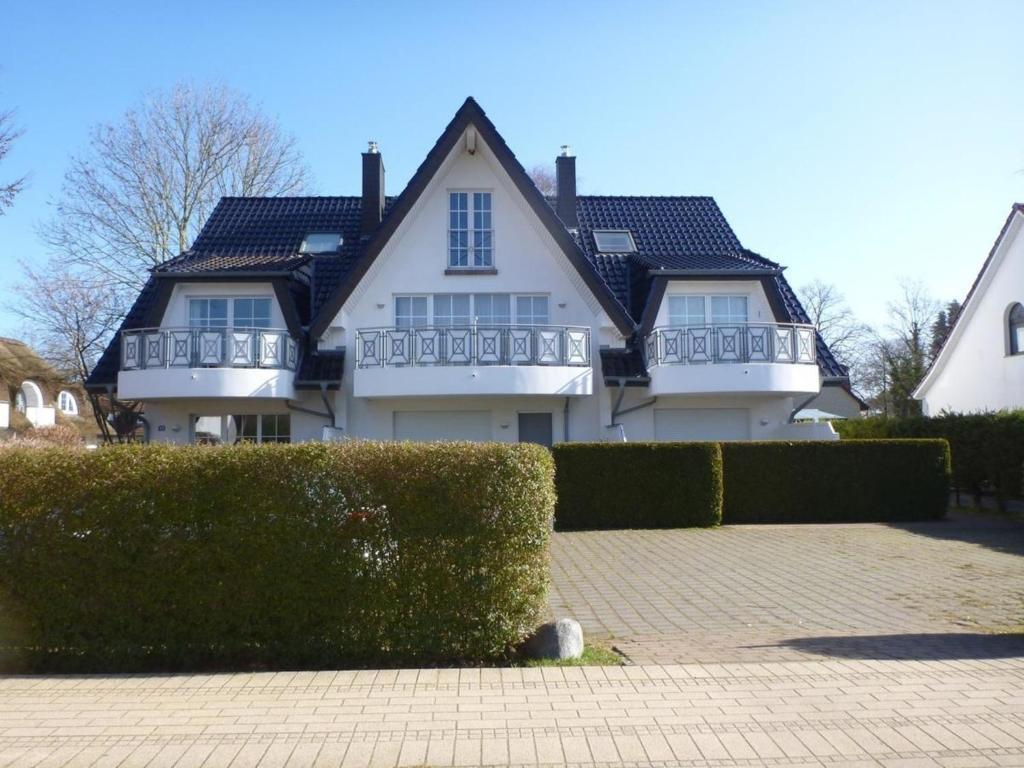 a large white house with a black roof at Sunshine in Zingst