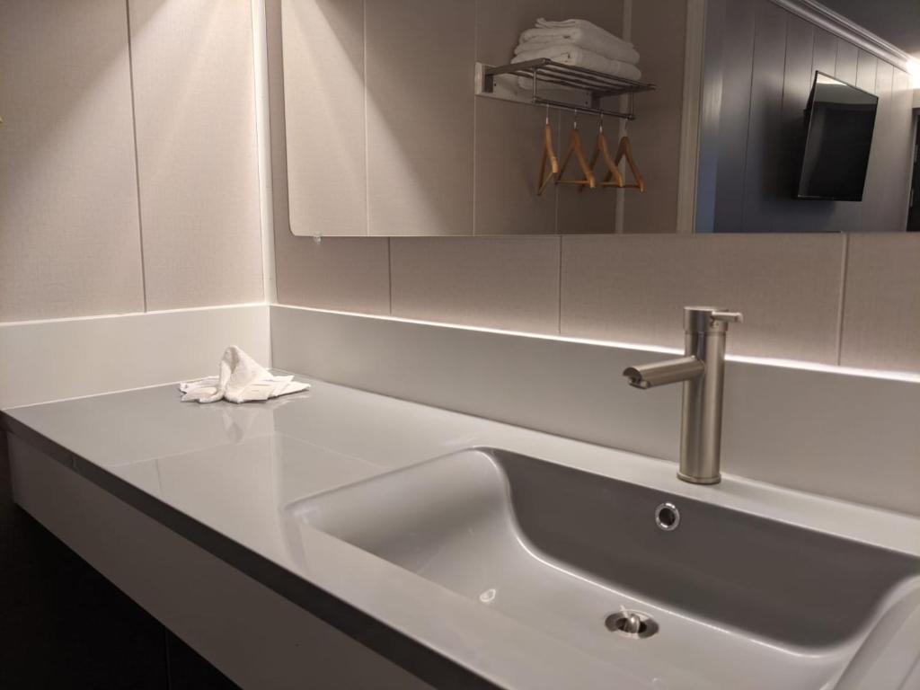 a white sink in a bathroom with a mirror at Stay Express Inn Chattanooga in Chattanooga
