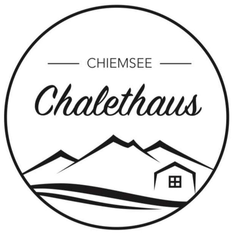 a logo for the chateau chateauichilles at Chalethaus-Chiemsee - Luxus 268 qm Ferienhaus am Chiemsee - Neubau in Prien am Chiemsee