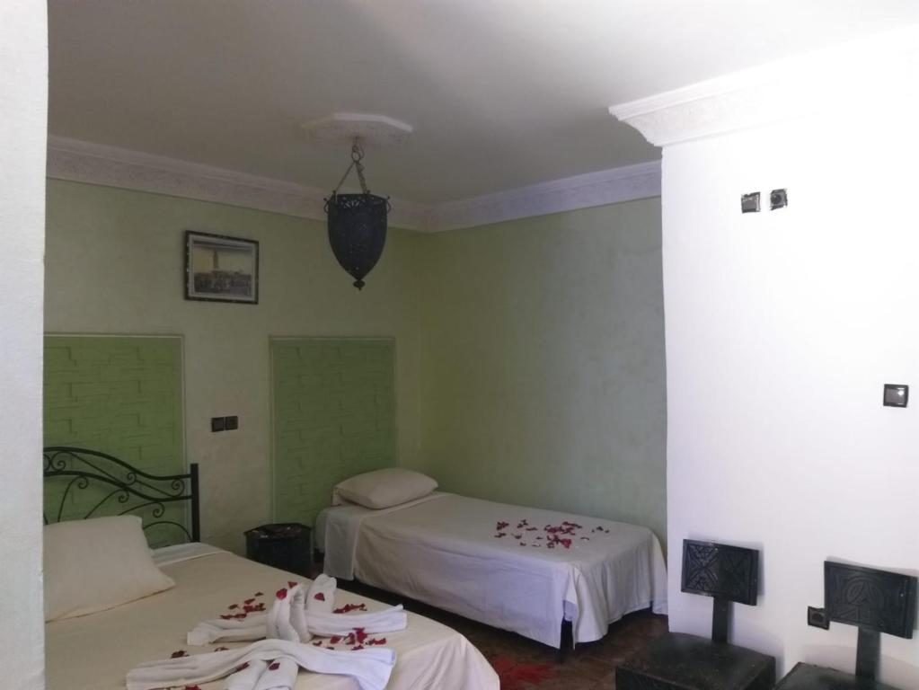 Postel nebo postele na pokoji v ubytování Hôtel Agnaou