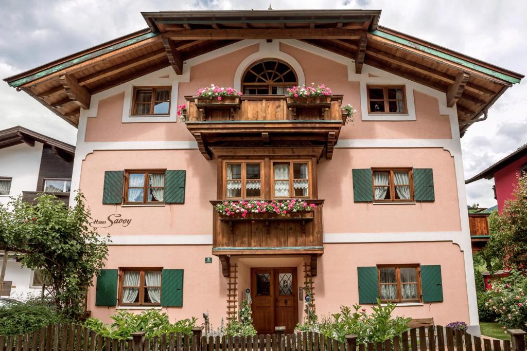 a house with a balcony and flowers on it at Haus Savoy - Appartement 1 in Kitzbühel