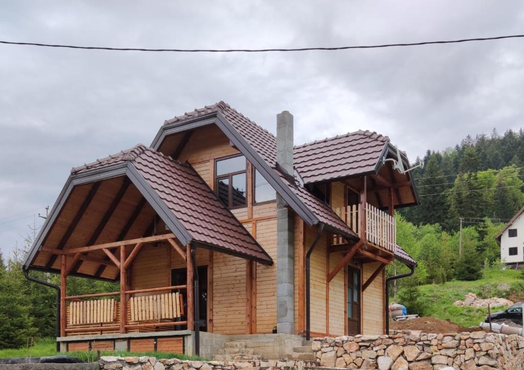 a log cabin with a gambrel roof at Brvnara Dolina jela in Bajina Bašta