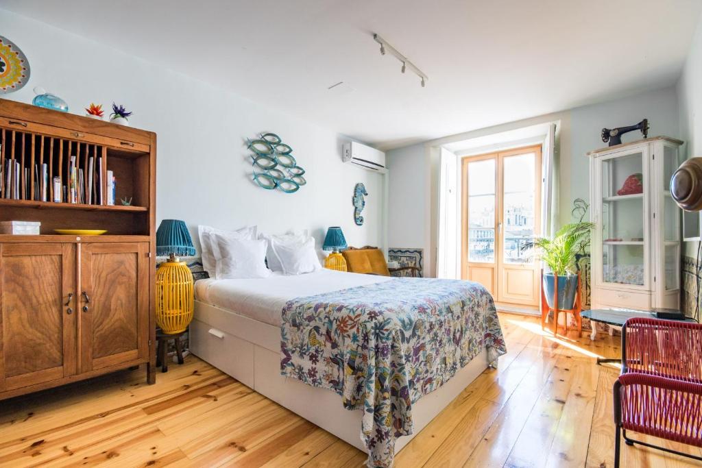 a bedroom with a bed and a wooden floor at Lisbon Heart Apartments - Yellow Apartment by LovelyStay in Lisbon