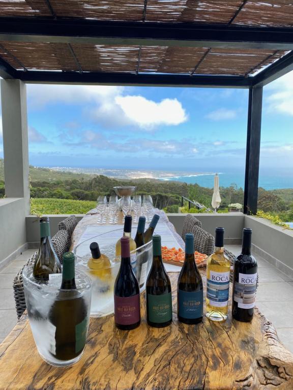 a table with wine bottles on a table with a view at Quinta Vale da Roca in Sintra