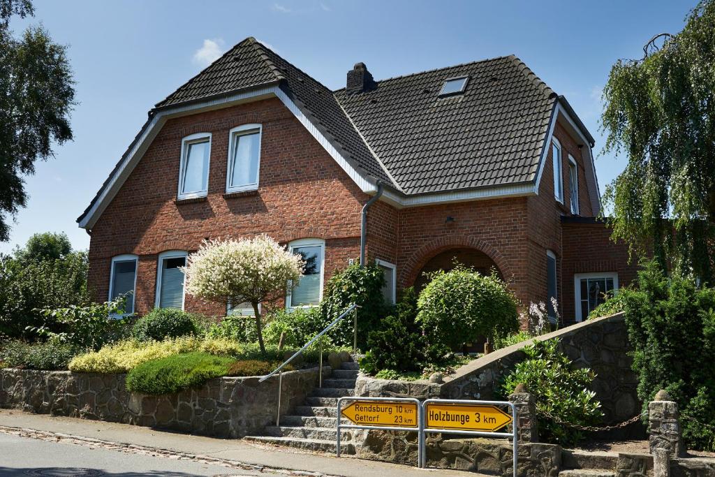 a brick house with a sign in front of it at Ferienwohnung Schröder - 2347 in Bünsdorf