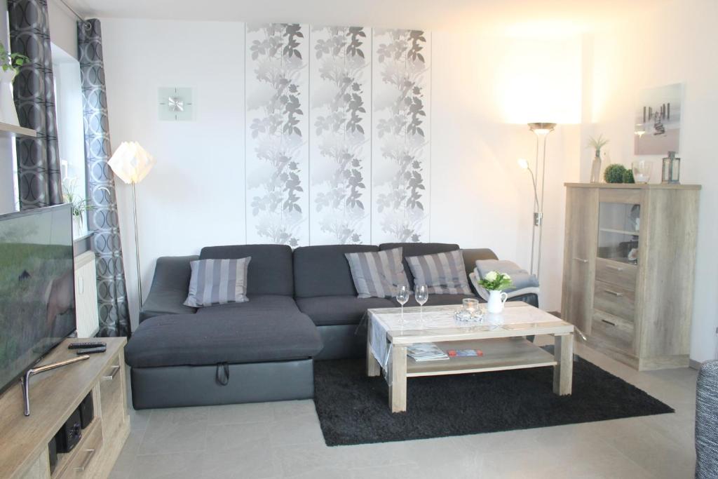 a living room with a couch and a coffee table at Ferienwohnung Steffens - "Lübecker Straße" in Grömitz