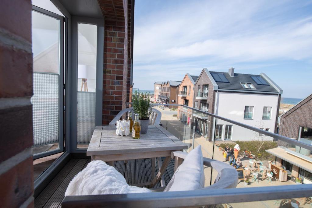 a balcony with a table and a view of a city at Ostsee - Appartement Nr 70 "Beachklause" im Strand Resort in Heiligenhafen