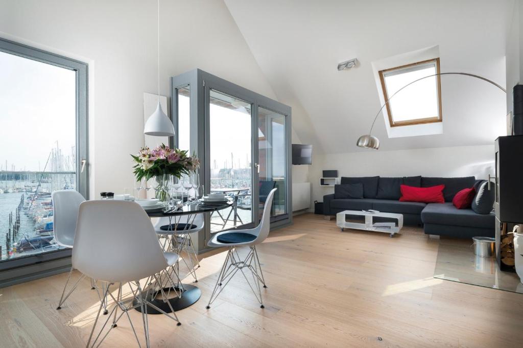 a living room with a couch and a table at Ostsee - Appartement Nr 55 "Marina Loft" im Strand Resort in Heiligenhafen