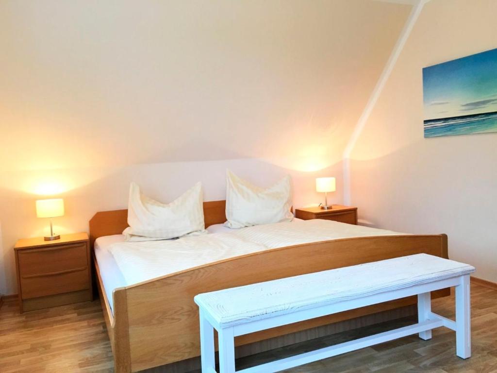1 dormitorio con 1 cama grande y 2 lámparas en Haus am Kurpark - Strandmuschel en Grömitz