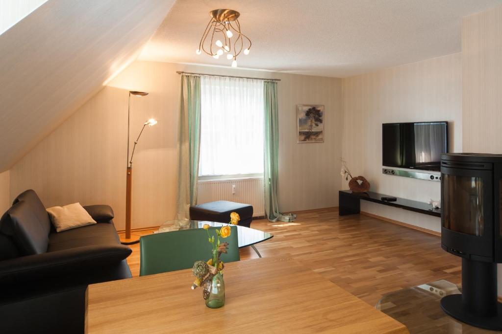 a living room with a couch and a table at Gustavs Apartment in Zingst