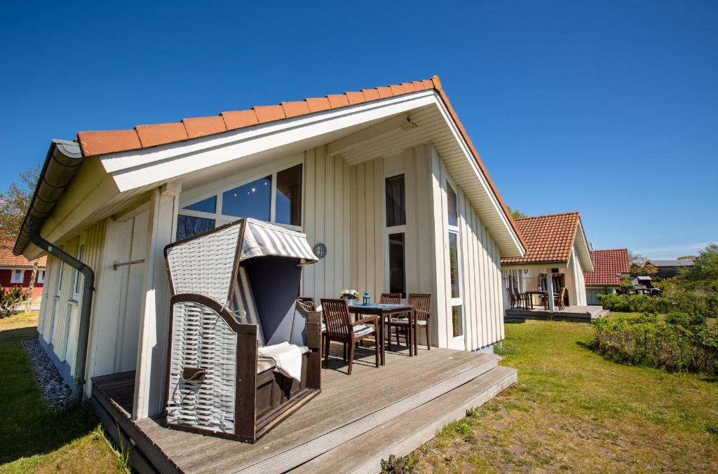 una casa con terrazza arredata con tavolo e sedie di Typ A "Black Pearl" -Kleiner-Belt-Haus- a Pelzerhaken