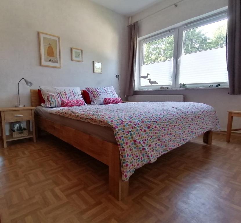 a bedroom with a bed in a room with two windows at FW Einfeldt in Hinrichsdorf