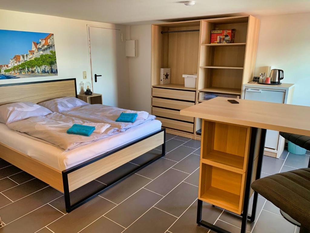 a small bedroom with a bed and a desk at Segellast 5 in Lübeck