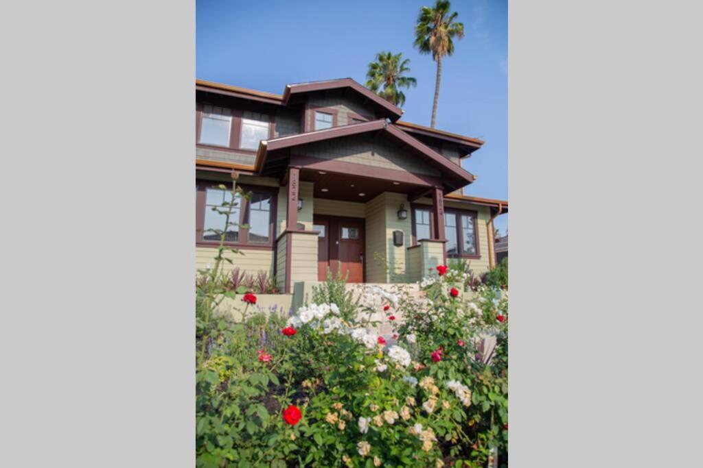 a house with flowers in front of it at HISTORIC 2 Story Near DTLA/USC/LAFC/STAPLES CENTER in Los Angeles