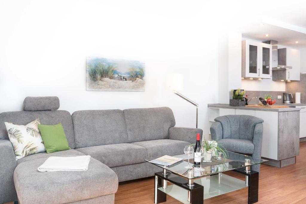 a living room with a couch and a table at W6 - Gästehaus Christian-Westphal-Str 60 - FERIENDOMIZIL HOLLICH in Grömitz
