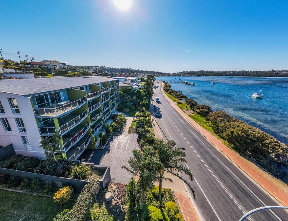 an aerial view of a building and a road next to the water at Albacore Apartments in Merimbula