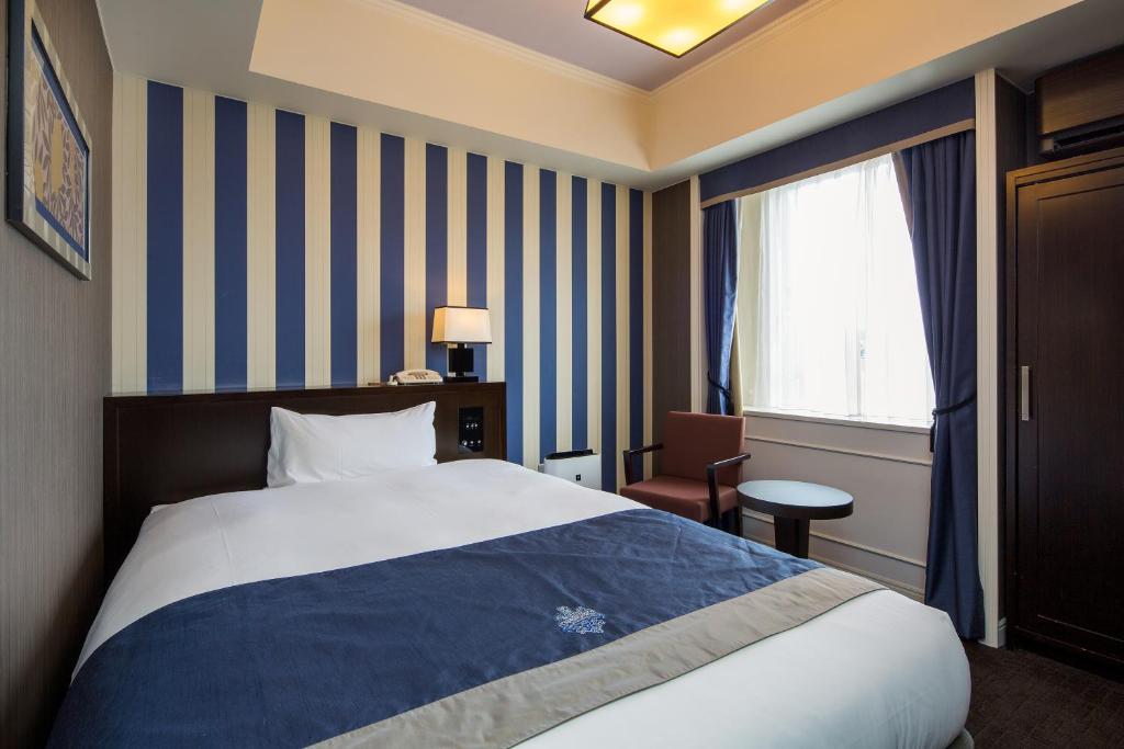 Postel nebo postele na pokoji v ubytování Hotel Monterey Kyoto