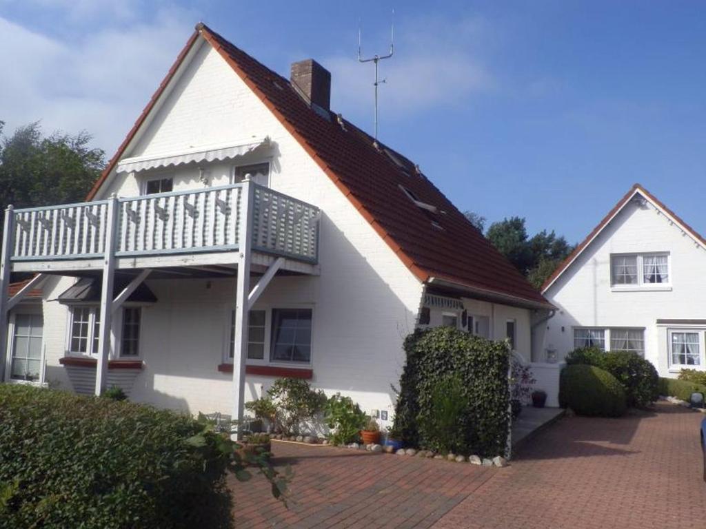 Casa blanca con techo rojo en Maisfeld Wohnung, en Wyk auf Föhr
