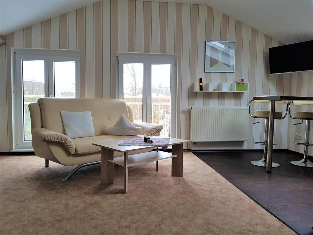 a living room with a couch and a table at Haus Bethania Ferienwohnung piccolo in Bad Kissingen
