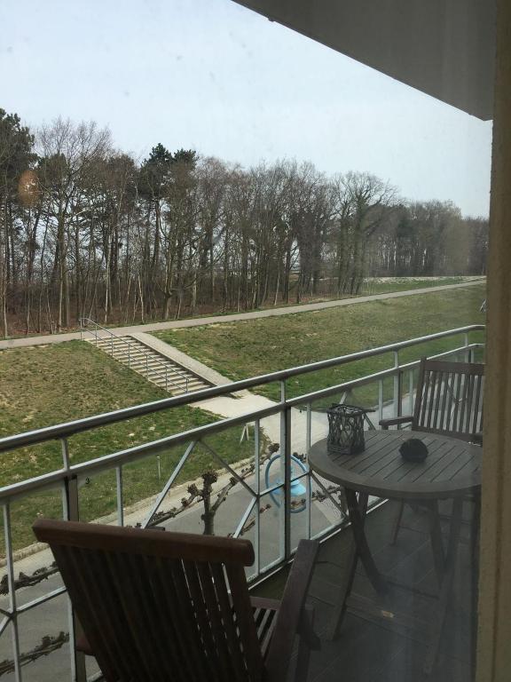 a balcony with a table and a view of a field at Meerlust App 6 in Zingst