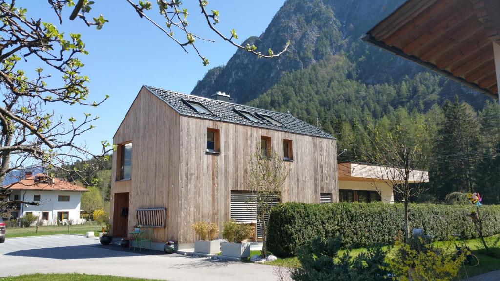 a wooden house with a mountain in the background at Ferienhaus Casa Rosa - LienzOsttirol in Leisach