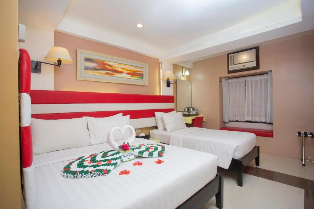 Postel nebo postele na pokoji v ubytování Red Coco Inn de Boracay