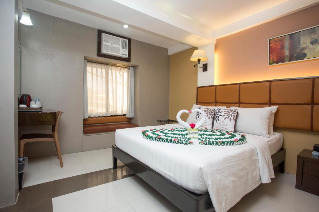 Postel nebo postele na pokoji v ubytování Red Coco Inn de Boracay