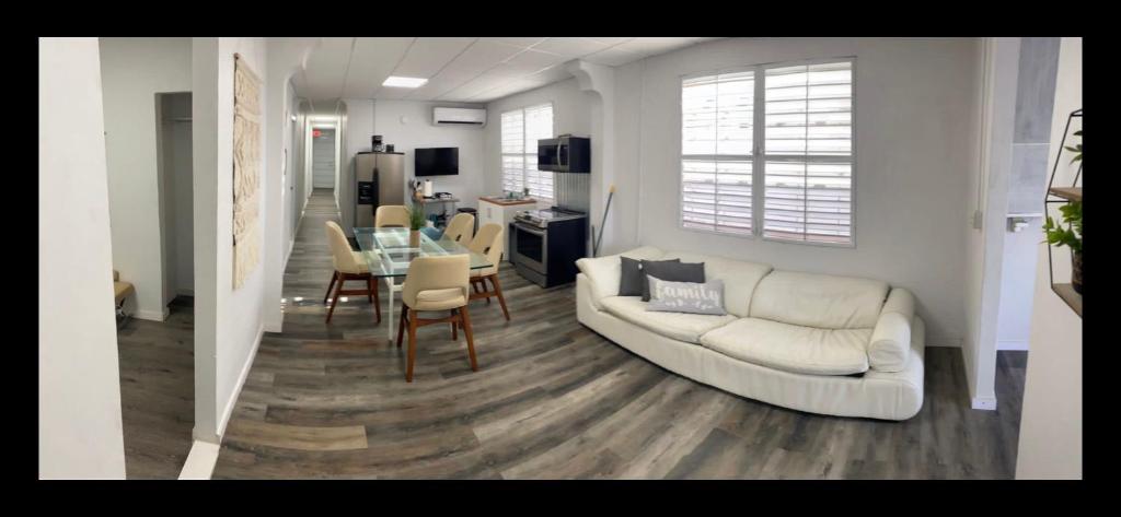 a living room with a white couch and a table at Large 9 bedroom home San Juan Puerto Rico in San Juan