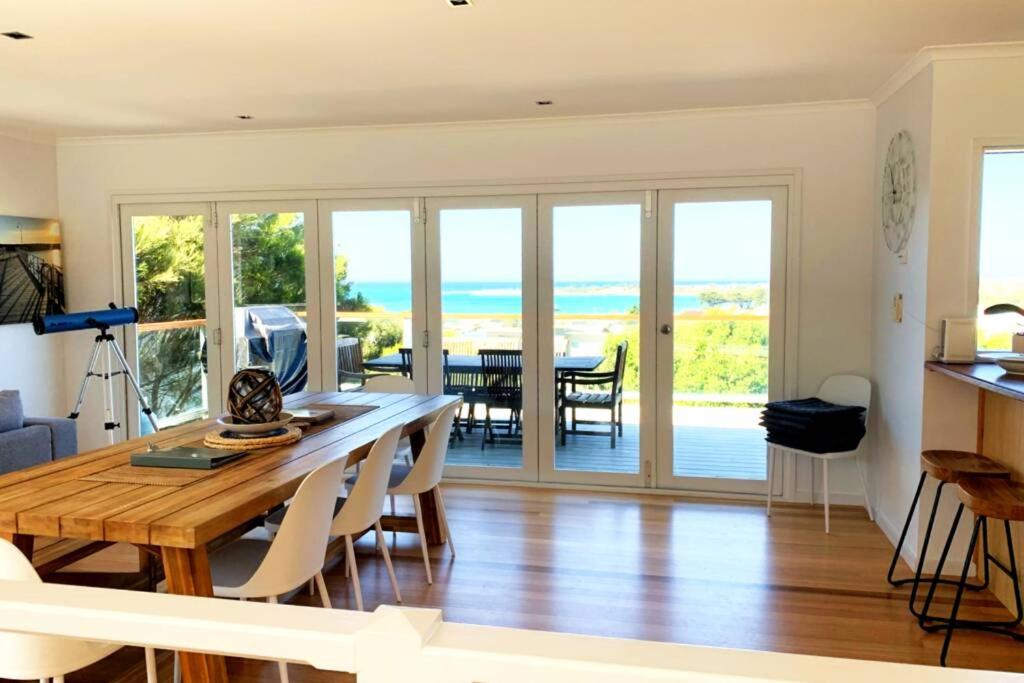 a kitchen and dining room with a table and chairs at Apollo Ocean Blue ~ Oceanview ~Wifi ~Pet Friendly in Apollo Bay