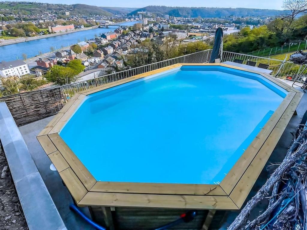 a large swimming pool on top of a building with a river at Beautiful holiday home in Huy with a terrace in Huy