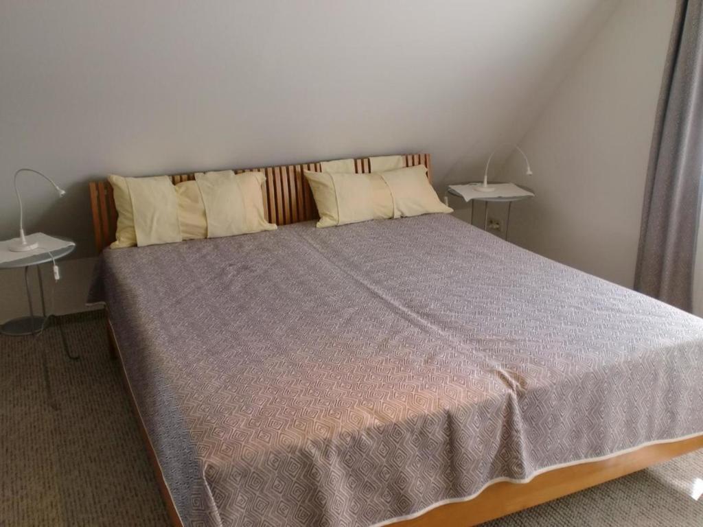 a bedroom with a large bed with two side tables at Ostseebrise 1 in Zingst