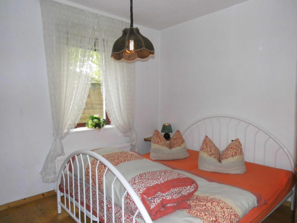a white crib in a bedroom with a window at Studio zur Weide in Heiligenhafen
