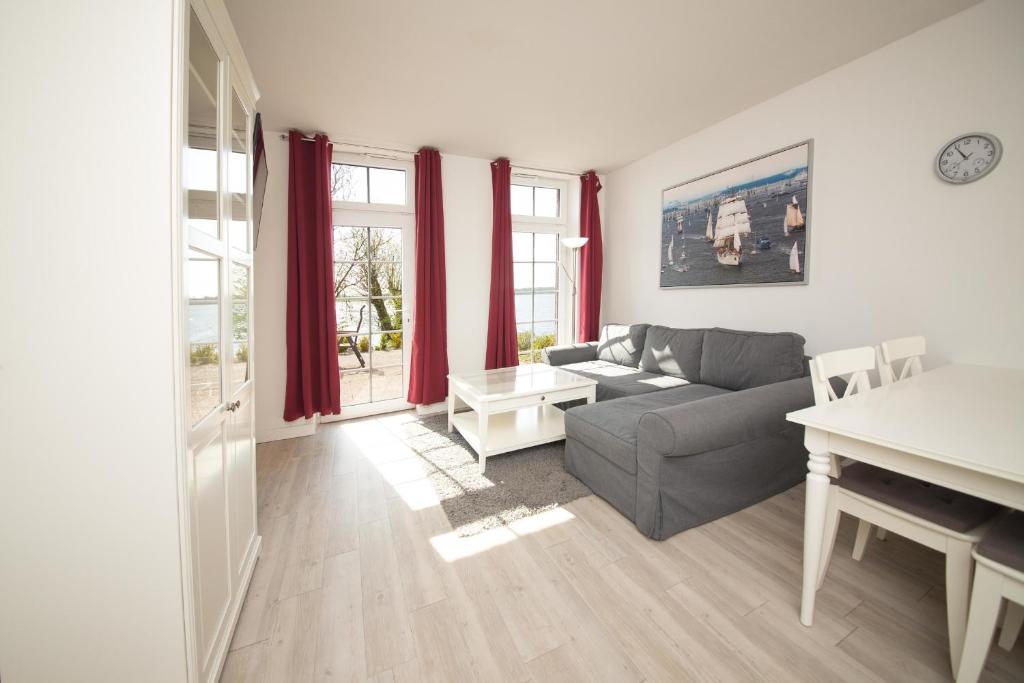 a living room with a couch and a table at Schleiblick App 9 in Rabenkirchen-Faulück