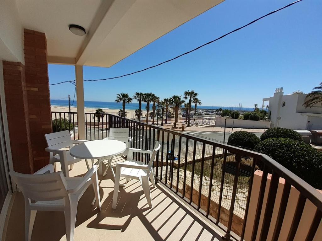 a balcony with a table and chairs and the beach at Apartamentos Dins Mar Apto. 6 in Torredembarra